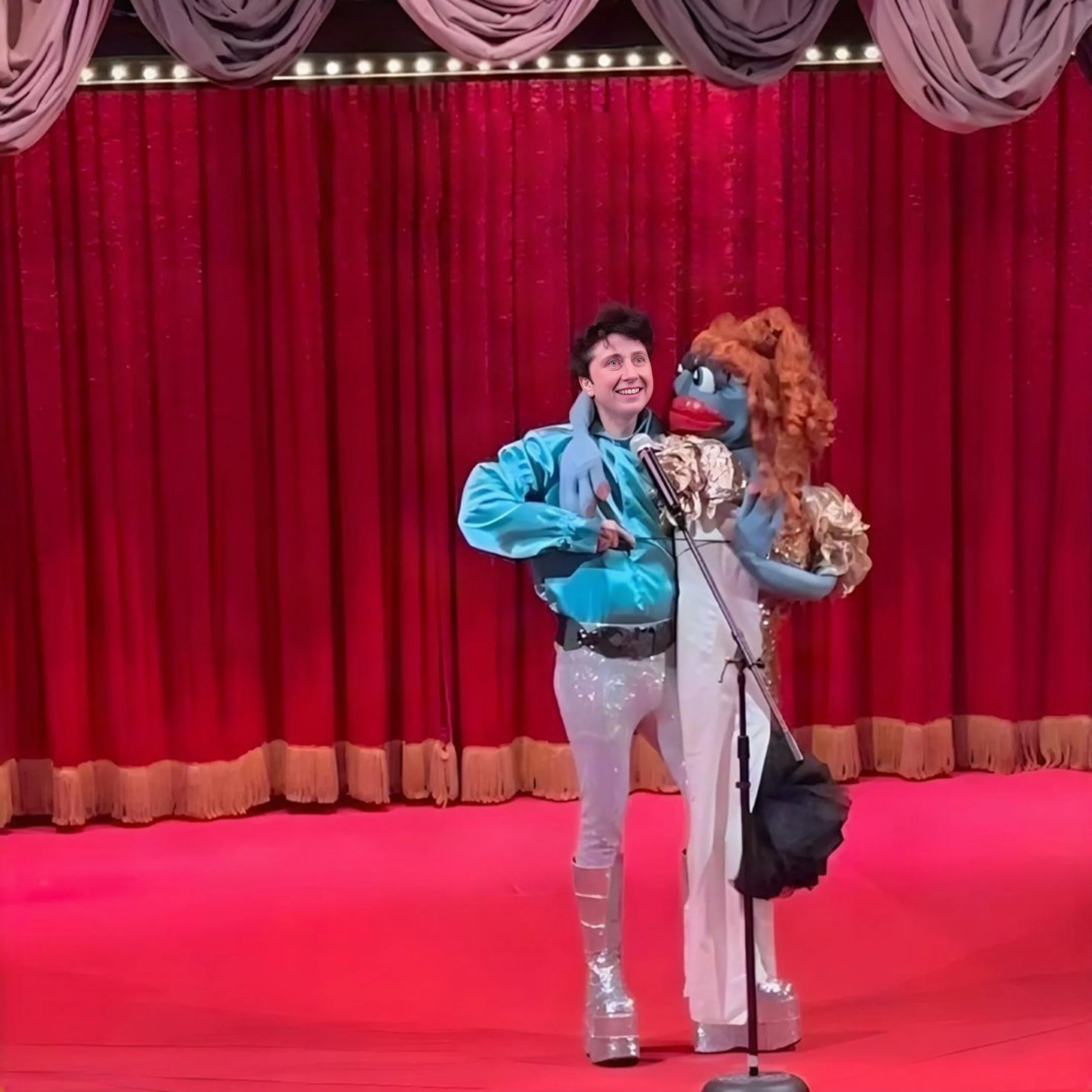 Zack & Ticklemuff performing on stage in front of red curtains