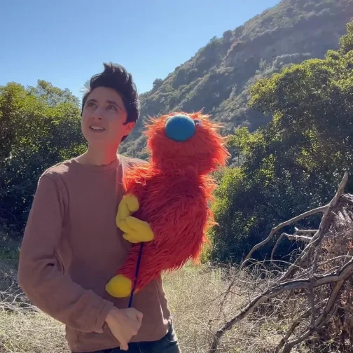 Zack and Ticklemuff outdoors outdoors with a hillside in the background