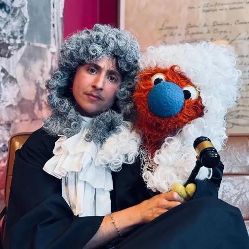 Zack and Ticklemuff dressed as judges with powdered wigs and a gavel